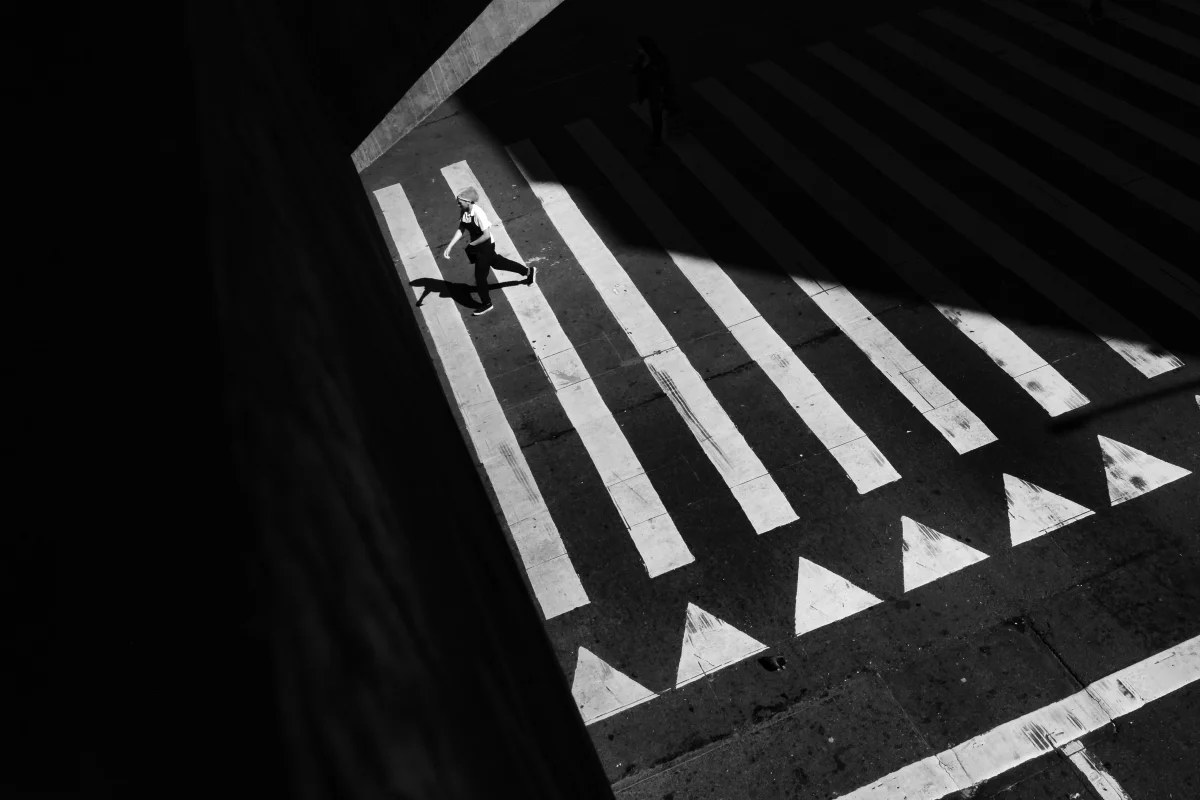 People crossing a wide street seen from above